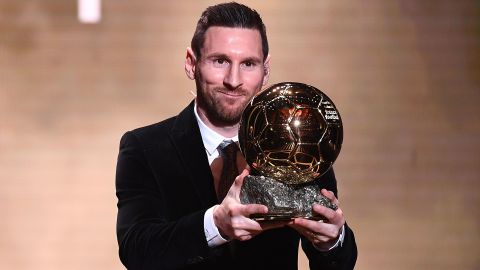 Messi poses with his sixth Ballon d'Or trophy in 2019. 