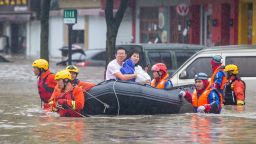 NINGBO, CHINA - JULY 25: Rescuers use a rubber boat to evacuate trapped people from a flooded street on July 25, 2021 in Ningbo, Zhejiang Province of China. Typhoon In-Fa made landfall in east China's Zhejiang Province at around 12:30 p.m. on Sunday, bringing heavy downpours and strong winds. (Photo by Chen Zhongqiu/VCG via Getty Images)