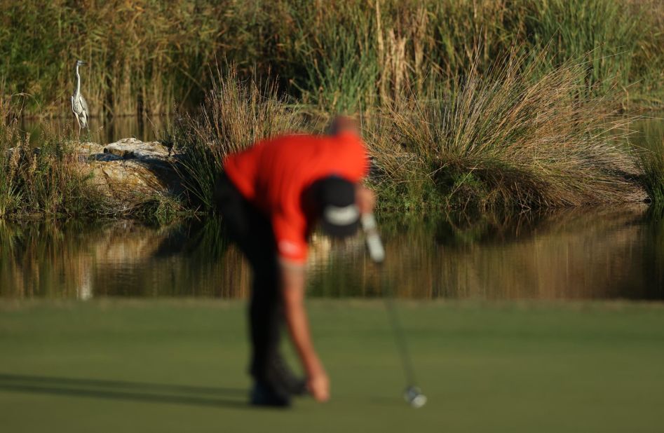 Matthieu Pavon holes his putt as a stork watches on from behind the 17th green during the third round of the Portugal Masters at Dom Pedro Victoria Golf Course in Quarteira, Portugal in 2021. 