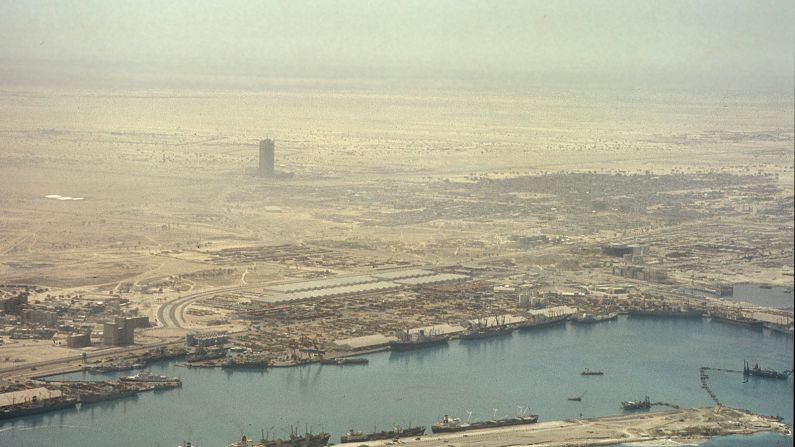 "Off Centre / On Stage" is an exhibition of photographs of the city taken between 1976 and 1979 by British architects Stephen Finch and Mark Harris. The exhibition shows Dubai at the point at which it was beginning to be reimagined as a city of awe-inspiring architecture. This bird's-eye view above Port Rashid, from 1977, looks out toward the World Trade Centre, Dubai's first skyscraper, which was under construction.