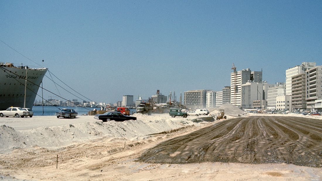 This photograph of Baniyas Road was taken in 1977. The road is being extended on land that has been recently reclaimed from the waters of Dubai Creek. As you look further inland, you see how the area has been developed with recently built office towers. The tallest building in the photograph was the tallest building in Dubai until the construction of the World Trade Centre, according Reisz.