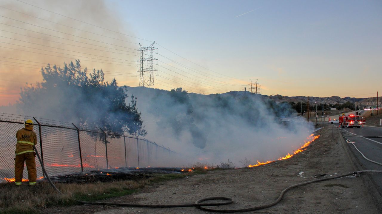 Firefighters contain a two-acre brush fire in Los Angeles on November 25, 2021. 