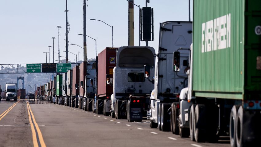 Trucks are lined up at the Port of Los Angeles on November 24, 2021 in San Pedro, California. The Ports of Los Angeles and Long Beach have suspended a plan to charge shippers fees for shipping container storage as a backlog of empty containers at the ports has decreased since last month.  