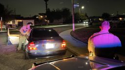 A deputy searches a car in Fresno. Getting stuck by a drug needle is a common hazard. 