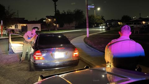 A deputy searches a car in Fresno. Getting pricked by a drug needle is a common hazard. 