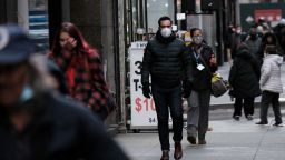 People wear face masks in Manhattan on November 29, 2021 in New York City. Across New York City and the nation, people are being encouraged to get either the booster shot or the Covid-19 vaccine, especially with the newly discovered omicron variant slowly emerging in countries around the world.