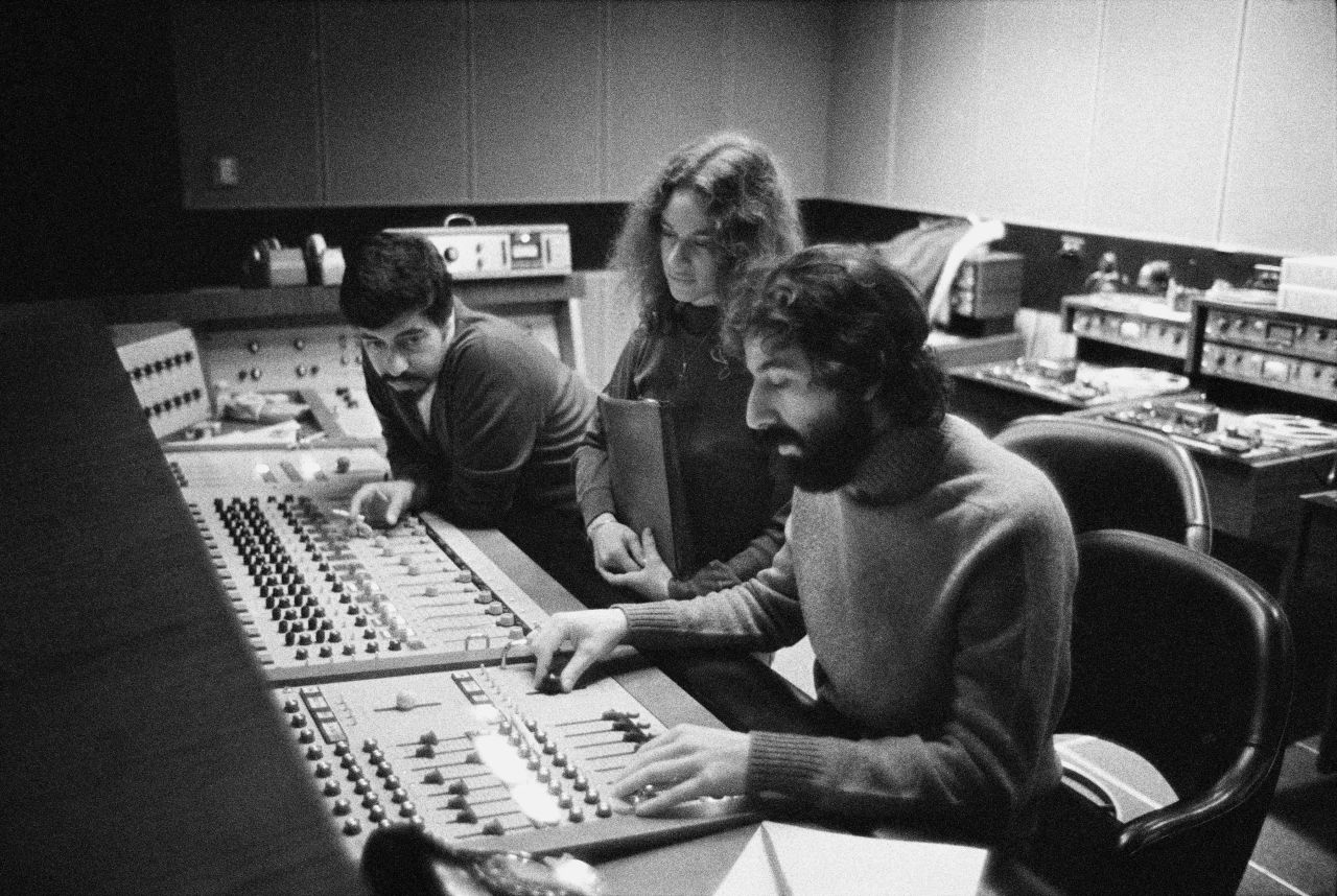 Recording engineer Hank Cicalo, King and record producer Lou Adler gather around the mixing desk in the control room during the recording of King's album, <a href="https://www.cnn.com/2021/02/10/entertainment/carole-king-tapestry-trnd/index.html" target="_blank">"Tapestry."</a> The album hit No. 1 on the <a href="https://www.billboard.com/music/music-news/carole-king-on-tapestry-album-history-6760843/" target="_blank" target="_blank">Billboard Hot 100</a> and stayed there for 15 weeks. It was the first album by a female artist to be certified as diamond, selling more than 15 million copies in 1971.