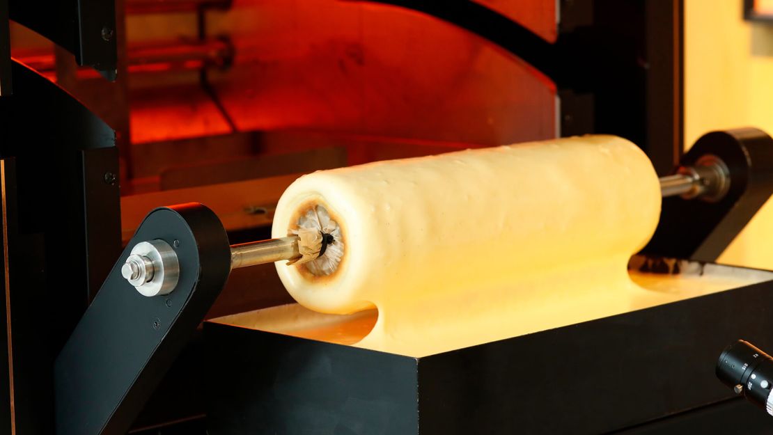Japan's Juccheim Group recently invented an AI oven that bakes Baumkuchen over a spit.