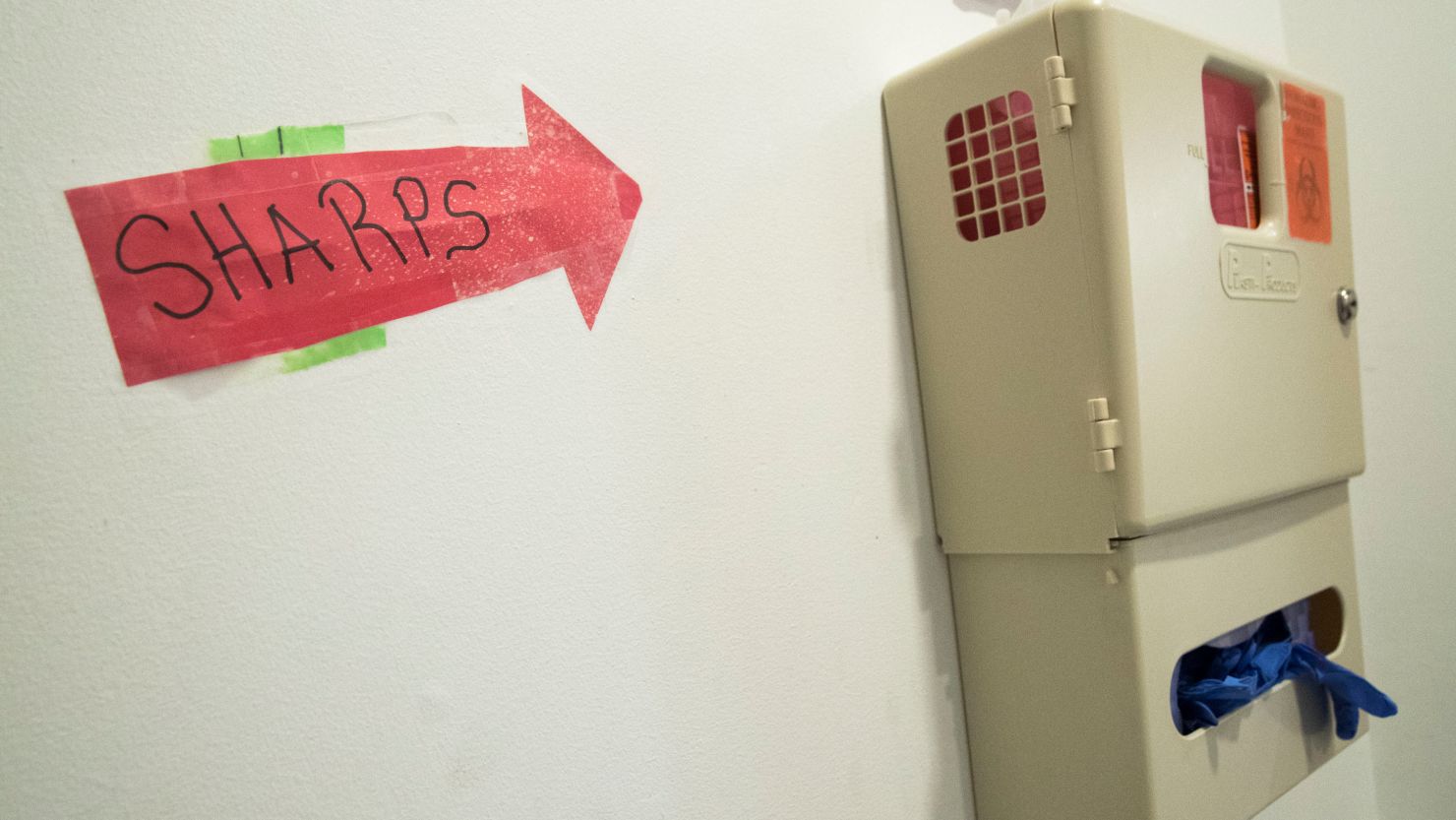 A safe needle disposal container is seen hanging in the bathroom of VOCAL-NY, a grassroots organization that builds power among low-income people directly impacted by HIV/AIDS, the drug war, mass incarceration, and homelessness, in Brooklyn on June 19, 2018.