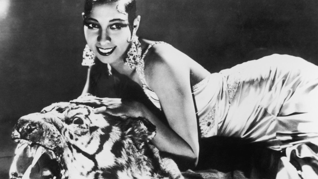 circa 1925:  Portrait of American-born singer and dancer Josephine Baker (1906 - 1975) lying on a tiger rug in a silk evening gown and diamond earrings.  (Photo by Hulton Archive/Getty Images)