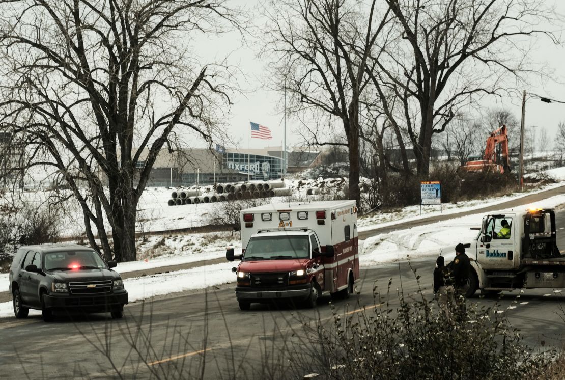 An ambulance sits at a road block restricting access to Oxford High School following the shooting.