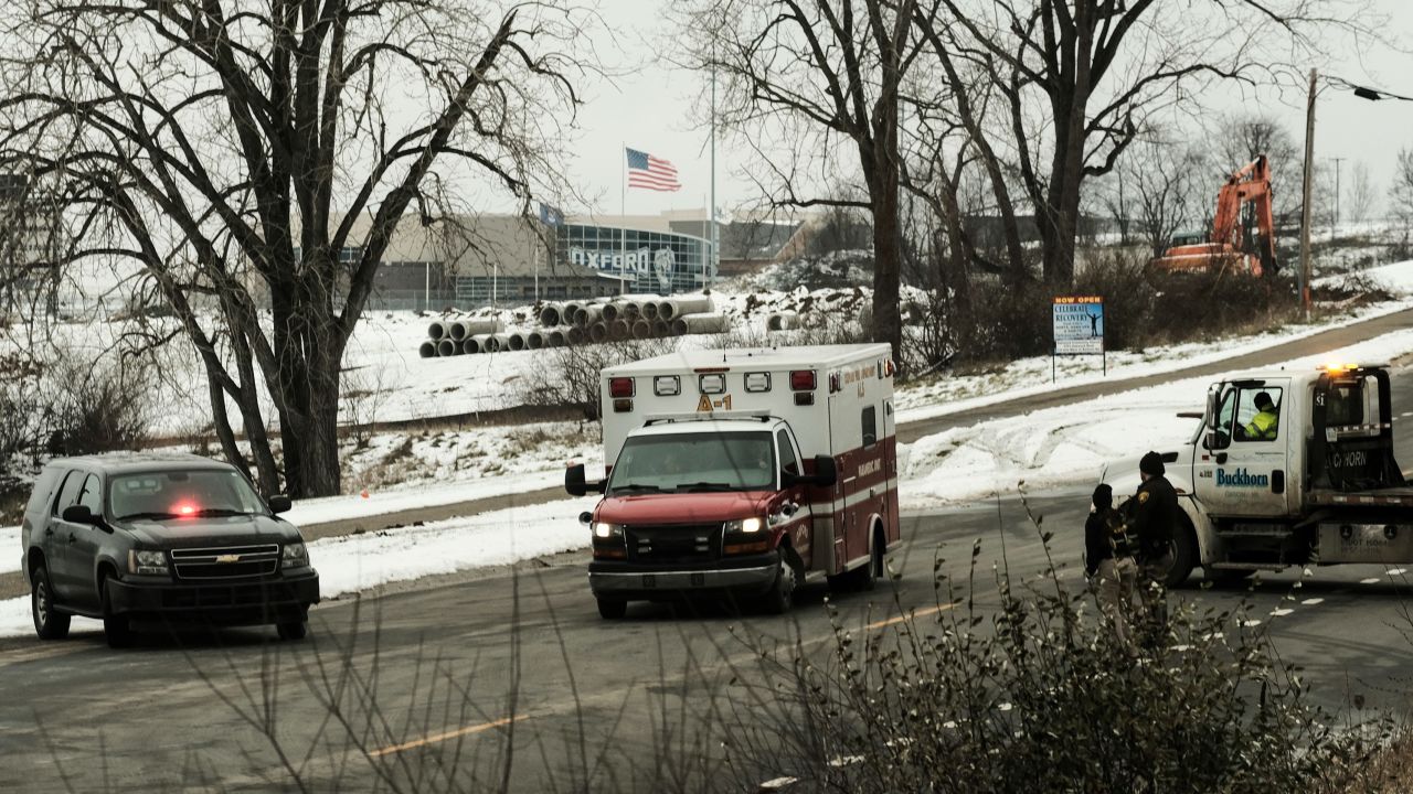 An ambulance sits at a road block restricting access to Oxford High School following the shooting.