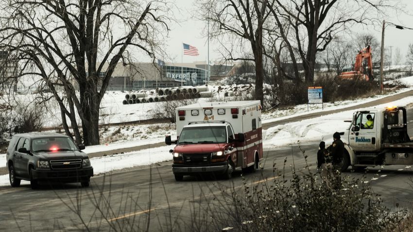 OXFORD, MI - NOVEMBER 30: An ambulance sits at a police road block restricting access to Oxford High School following a shooting on November 30, 2021 in Oxford, Michigan. According to reports, three people were killed and six others wounded by the alleged perpetrator, a 15 year old student who is now in police custody. (Photo by Matthew Hatcher/Getty Images)