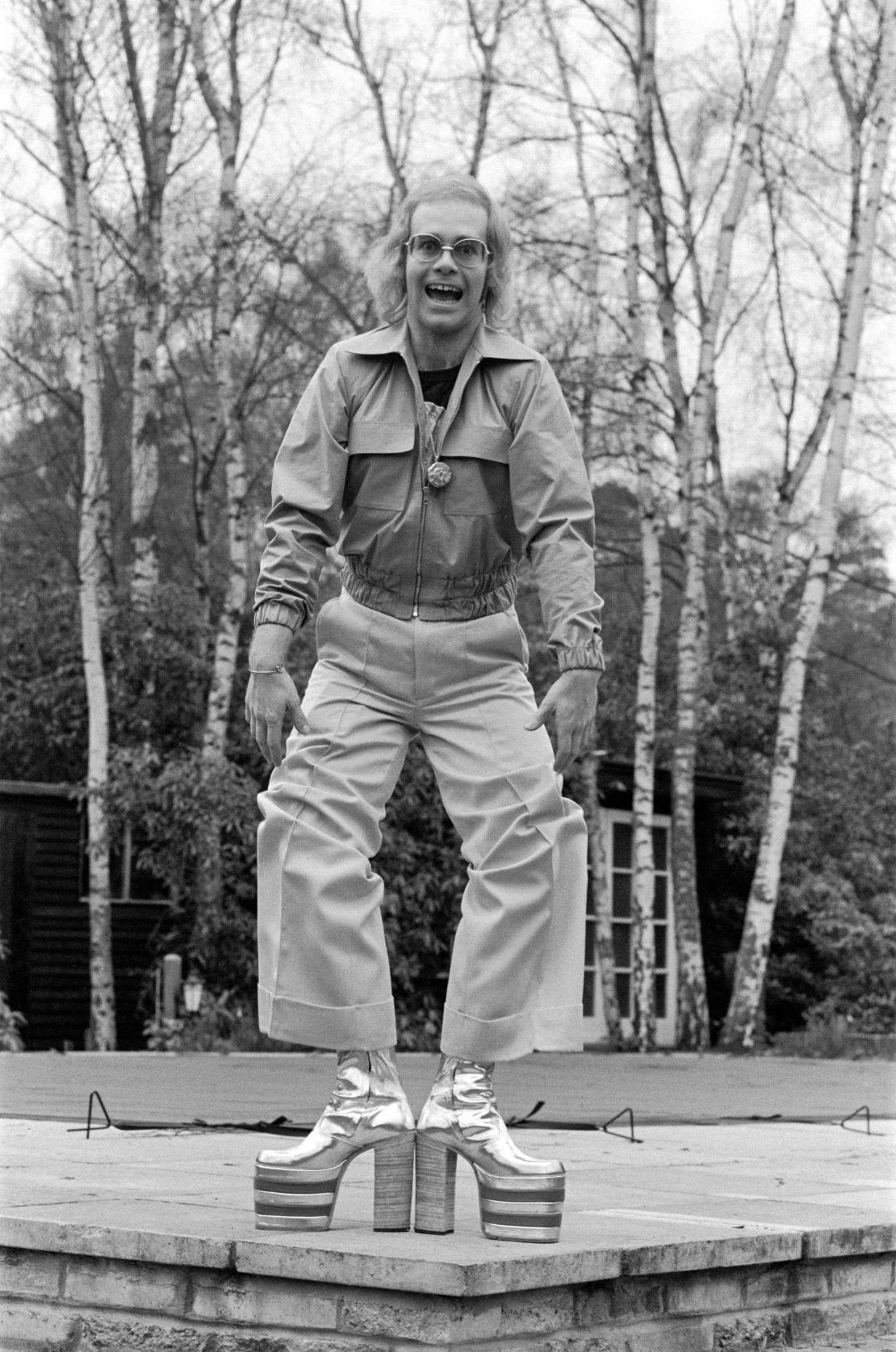 Elton John, pictured in 1973, wearing silver and red platform boots. Detailed with his initials E and J, the shoes are eight inches high and were created by Ken Todd of Kensington Market.