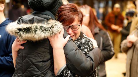 People hug during a vigil Tuesday following a shooting at Oxford High School in Michigan. 