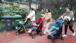 FUYANG, CHINA - NOVEMBER 29, 2021 - Three parents push strollers in Wenfeng Park in Fuyang City, Anhui Province, Nov 29, 2021. According to the "China Statistical Yearbook 2021" released by the National Bureau of Statistics on November 29, 2020, China's birth rate in 2020 was 8.52 per thousand, falling below 10 per thousand for the first time, showing single digits for the first time and hitting a new low since 1978. During the same period, the natural population growth rate (birth and death rates) was only 1.45 per thousand, also the lowest since 1978. (Photo credit should read An Xin / Costfoto/Barcroft Media via Getty Images)