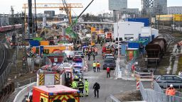 Firefighters, police officers and railway employees stand on a site at the Donnersbergerbruecke station on Wednesday.