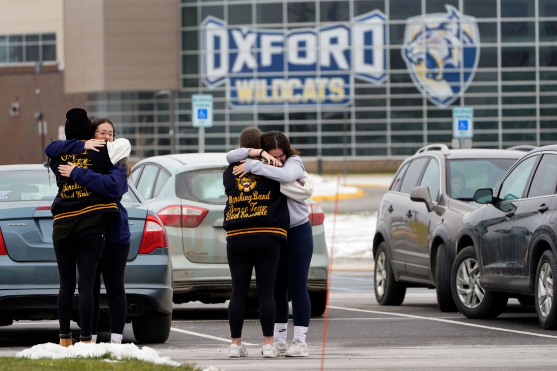 Students hug at outside Oxford High School in Oxford, Mich., Wednesday, December 1, 2021. 