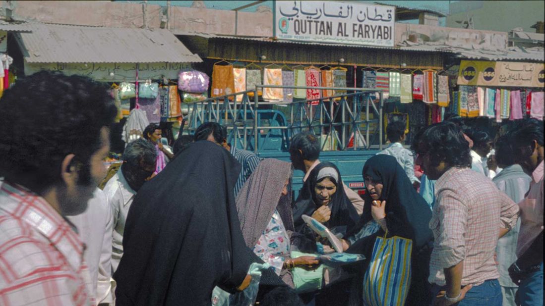 This is an image of "hustle," said Reisz, of this photograph of Deira Souk in 1977. "I really love that this image is of four women who are negotiating in the souk, and there are men around them waiting for their decision, trying to influence their decision-making, but also ready to hear, let's say, which one and how many they're willing to buy."