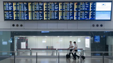 Cathay Pacific pilots seen wearing face masks exiting the arrival hall at the Hong Kong International Airport terminal.