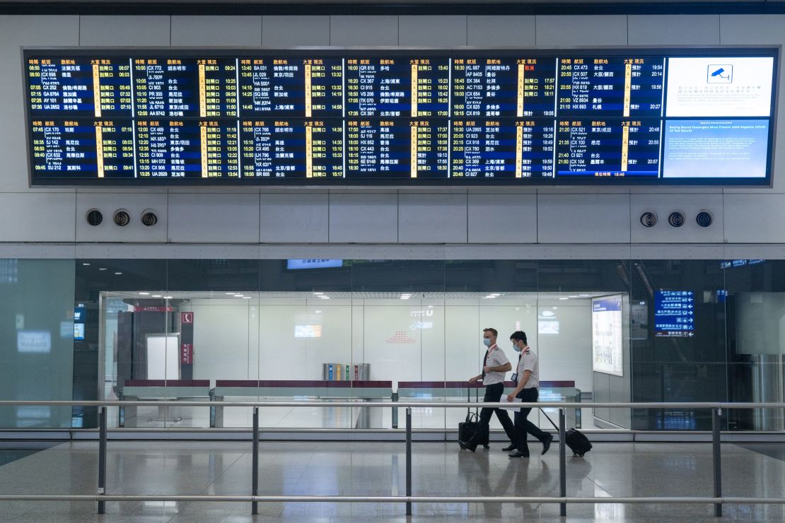 Cathay Pacific pilots seen wearing face masks exiting the arrival hall at the Hong Kong International Airport terminal.