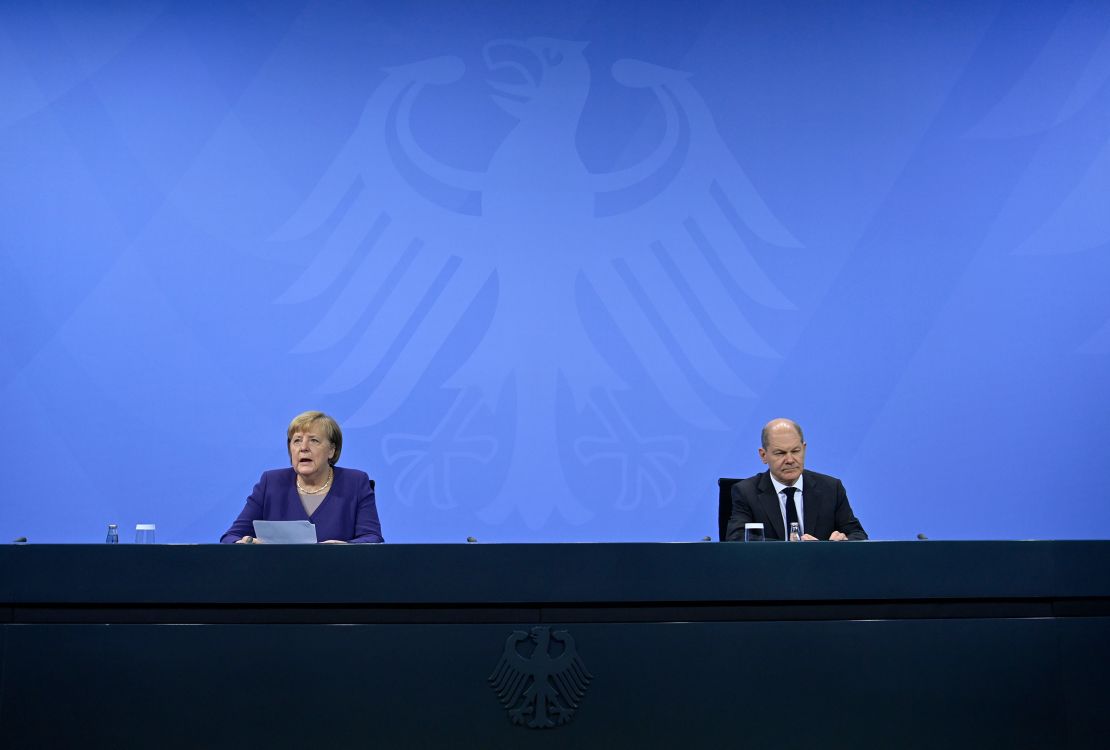 Acting Chancellor Angela Merkel and Olaf Scholz hold a press conference on tightened Covid-19 restrictions Thursday. 