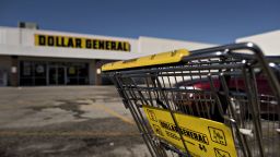 A shopping cart sits in a parking lot outside a Dollar General Corp. store in Moline, Illinois, U.S., on Wednesday, March 11, 2015. 
