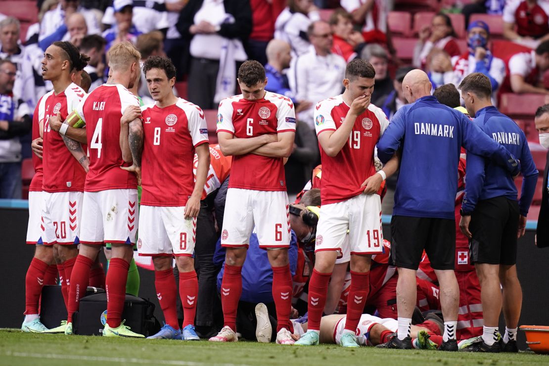 Denmark's players react as paramedics attend to Eriksen after he collapsed on the pitch in June, 2021.