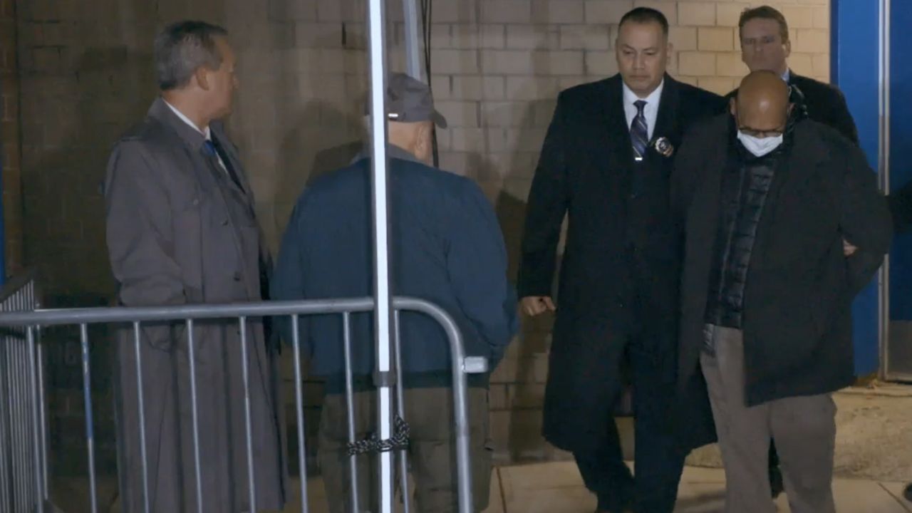 Reiman, left, and Lagiovane look on as Det. Dominic Robinson and Sgt. Tom McLaughlin (back right) escort Martinez.