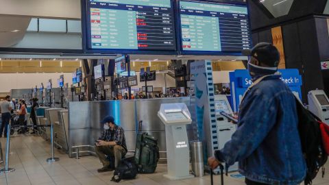 A traveler looks at an electronic board displaying canceled flights at the O.R. Tambo International Airport in Johannesburg on Saturday, November 27. A new and potentially more transmissible coronavirus variant — <a href="https://www.cnn.com/2021/11/26/health/omicron-variant-what-we-know/index.html" target="_blank">a strain named Omicron</a> — has prompted a fresh round of travel restrictions across the world. While scientists say there is reason to be concerned over Omicron, they stress there is still a lot we don't know — including whether the variant is indeed more contagious, whether it causes more severe disease or what its effects on vaccine efficacy may be.