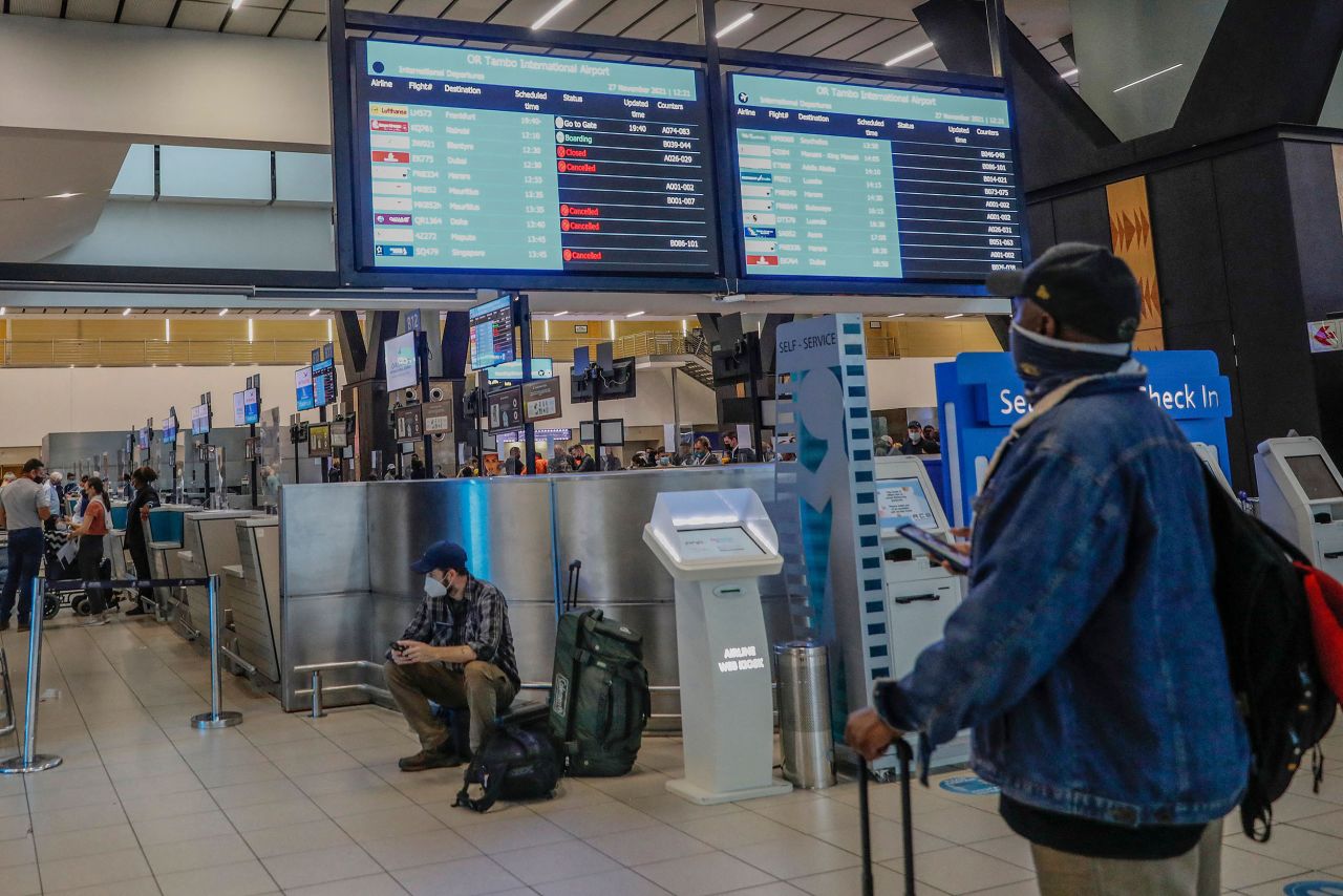 A traveler looks at an electronic board displaying canceled flights at the O.R. Tambo International Airport in Johannesburg on Saturday, November 27. A new and potentially more transmissible coronavirus variant — <a href="https://www.cnn.com/2021/11/26/health/omicron-variant-what-we-know/index.html" target="_blank">a strain named Omicron</a> — has prompted a fresh round of travel restrictions across the world. While scientists say there is reason to be concerned over Omicron, they stress there is still a lot we don't know — including whether the variant is indeed more contagious, whether it causes more severe disease or what its effects on vaccine efficacy may be.