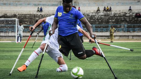 Tanzania's Alfan Kiyanga, front, is challenged by a Moroccan player during the opening match of the Cup of African Nations for Amputees. Tanzania, the hosts of the inaugural tournament, won the match 2-1 on Saturday, November 27.