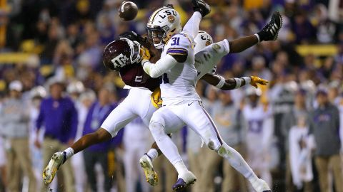 LSU's Cameron Lewis and Jay Ward break up a pass intended for Texas A&M's Ainias Smith during a college football game in Baton Rouge, Louisiana, on Saturday, November 27.