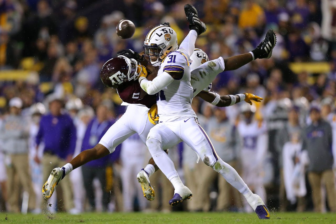 LSU's Cameron Lewis and Jay Ward break up a pass intended for Texas A&M's Ainias Smith during a college football game in Baton Rouge, Louisiana, on Saturday, November 27.