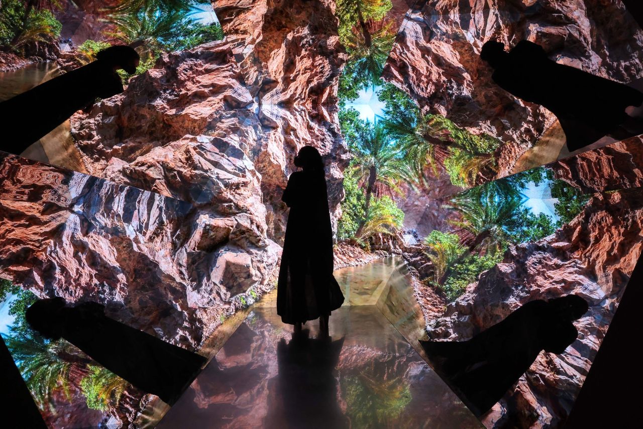 A woman looks at a video installation while attending the World Expo in Dubai, United Arab Emirates, on Wednesday, December 1.