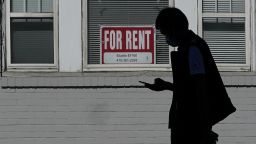 In this Oct. 20, 2020 file photo, a man walks in front of a For Rent sign in a window of a residential property in San Francisco.