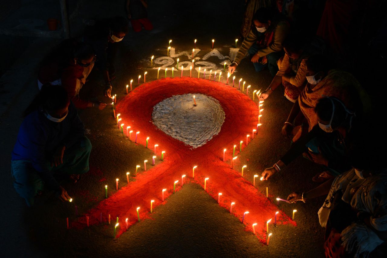 Candles form the shape of a red ribbon on Tuesday, November 30, during an event in Siliguri, India, raising awareness of World AIDS Day.