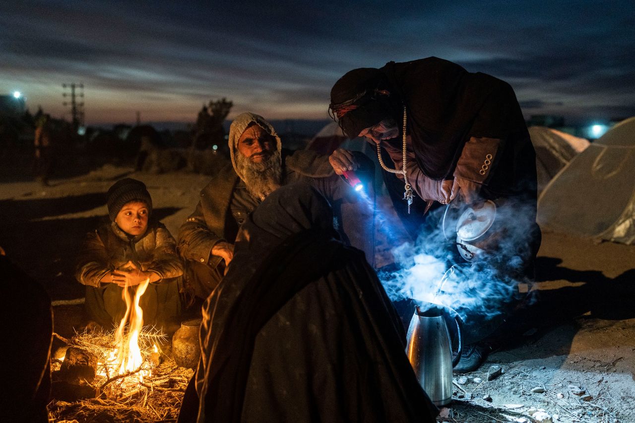 A family prepares tea as they camp in Herat, Afghanistan, on Monday, November 29. About 2,000 people left the village of Allahyar because of drought, and they are seeking help from the regional government in Herat.