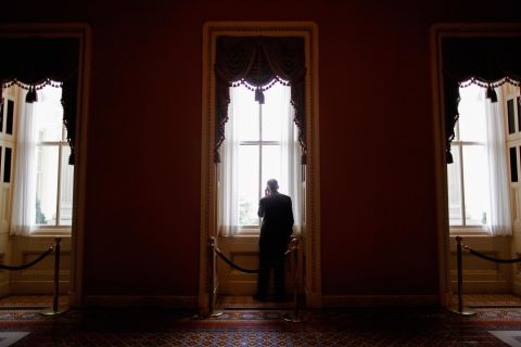 Reid steps out of a weekly Democratic policy luncheon to talk on the phone in 2011.