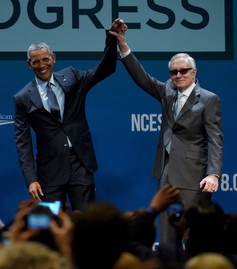 Reid holds up Obama's hand after the President delivered a keynote address at the National Clean Energy Summit in Las Vegas in 2015.