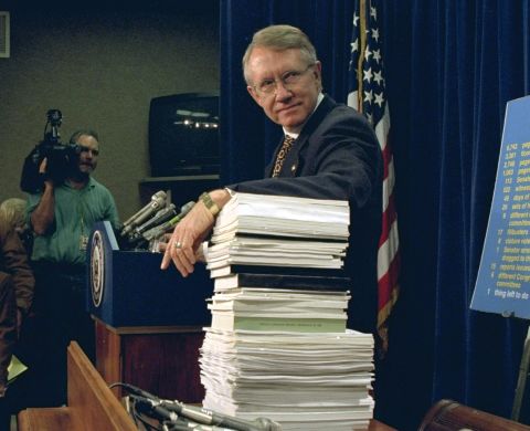 Reid leans on a stack of campaign finance reform documents during a Capitol Hill news conference in 1996.