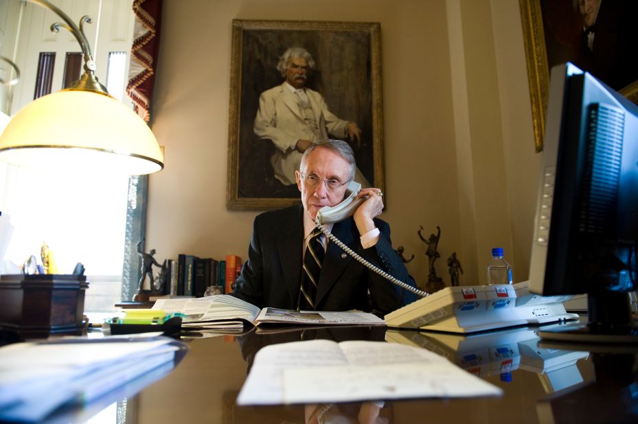 Reid talks at his desk in the Capitol in 2008.