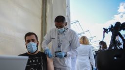 A young man goes to receive the vaccine against Covid-19, at a vaccination point installed on the occasion of the Festival de Les Arts, on November 4, 2021, in Valencia, Valencian Community, Spain. 