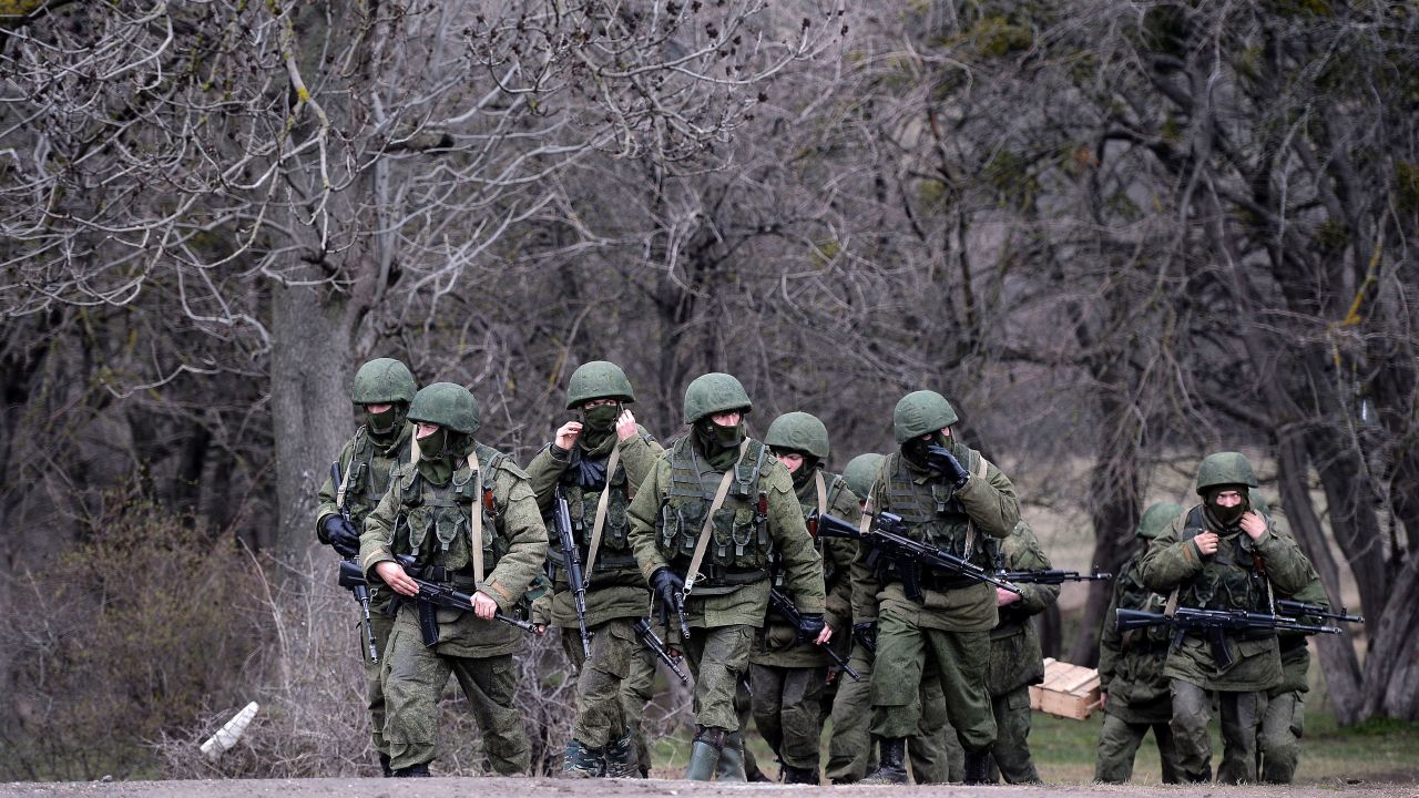Russian soldiers patrol the area surrounding the Ukrainian military unit in Perevalnoye, outside Simferopol, Crimea, on March 20, 2014.