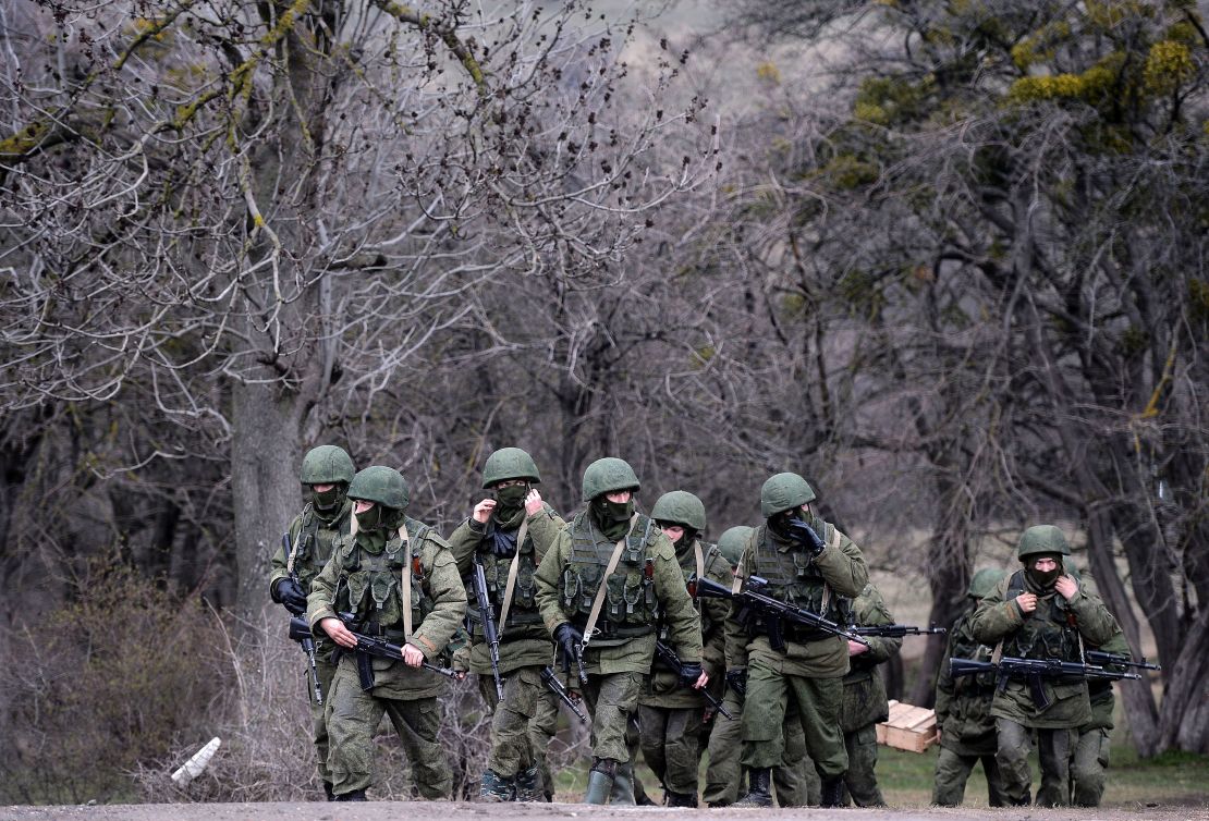 Russian soldiers patrol the area surrounding the Ukrainian military unit in Perevalnoye, outside Simferopol, Crimea, on March 20, 2014.