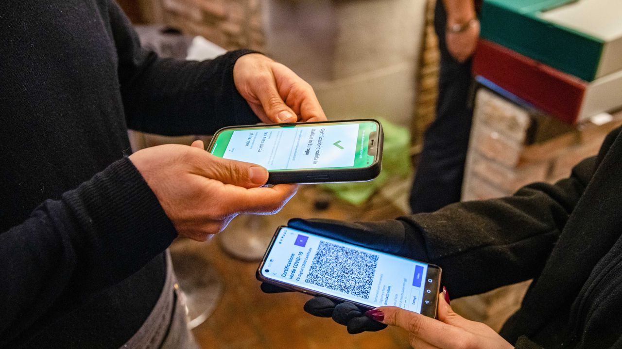 A customer has their Green Pass checked at a restaurant in Brescia, Italy on December 1, 2021. 