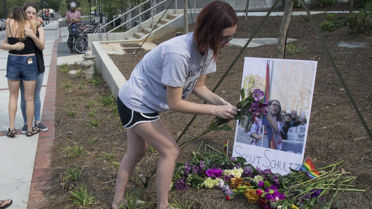 A mourner sets out flowers at a memorial for Georgia Tech student Scout Schultz in Atlanta, Georgia, on September 17, 2017.