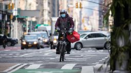 A bike messenger carries a DoorDash Inc. bag during a delivery in New York, U.S., on Wednesday, Dec. 9, 2020. \