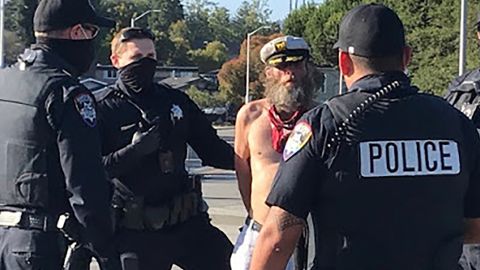 This photo provided by the Santa Cruz Police Department shows Ole Hougen being taken into custody by police officers in Santa Cruz, Calif., last year.