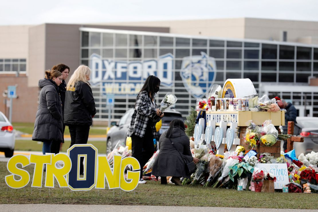 People gather at the memorial for the dead and wounded outside of Oxford High School in Oxford, Michigan, on December 3, 2021. 